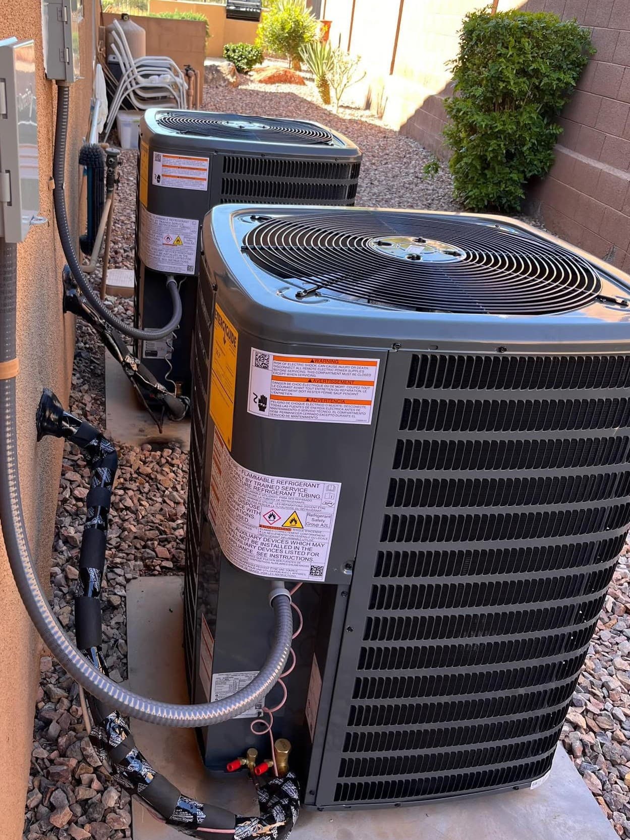 Split system AC condenser installation at a Phoenix, Arizona residential home